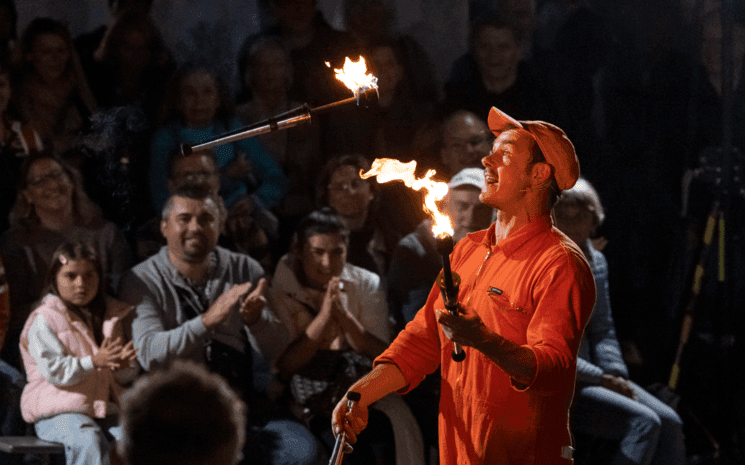 Spectateurs regardent un cracheur de feu.